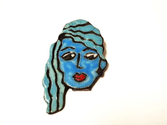 Brosche mit blauem Gesichtsporträt
