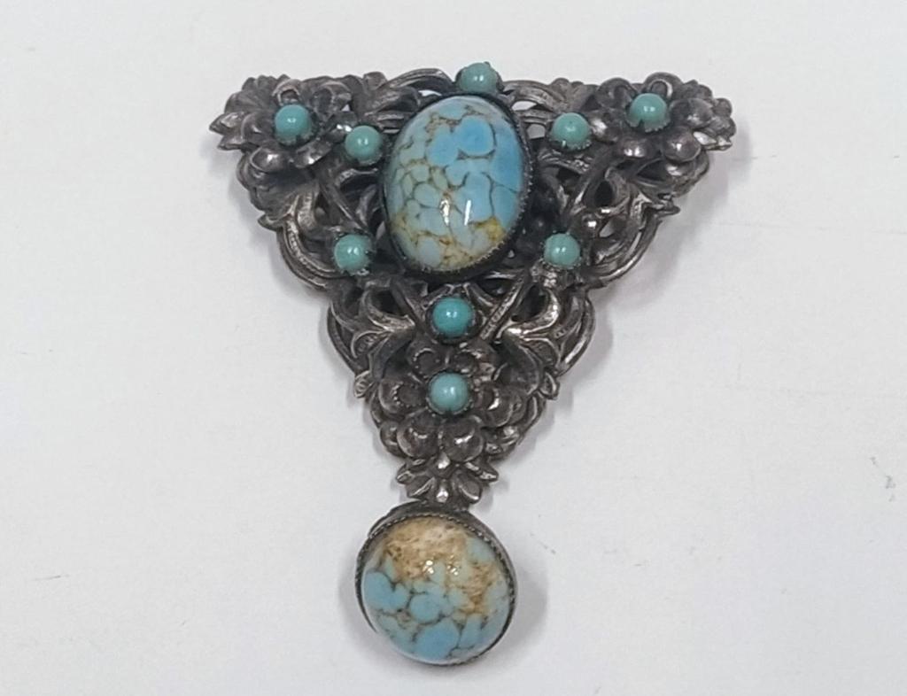 Ornate vintage pressed metal brosche with turquoise details